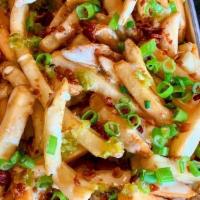 *Loaded Fries · Thick cut fresh fries topped w/ house-made Ranch queso, chopped bacon, scallions & diced hou...
