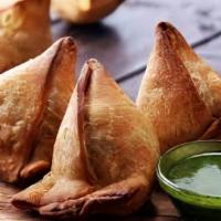Samosa (2) · Vegan. A deep-fried snack, triangular shell made of flour, filled with potato and peas based...