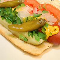 Chicago Hot Dog · Chicago's Vienna All beef hot dog topped with mustard, tomato, onions, green relish, sport p...