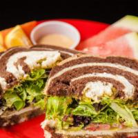 The Dallas · Sliced oven gold turkey, swiss cheese, mixed greens, tomatoes, jalapenos, hummus, and guacam...