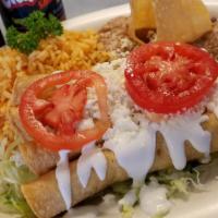 Flautas De Pollo · 3 Flute shaped crispy tacos stuffed with shredded chicken breast topped with sour cream and ...