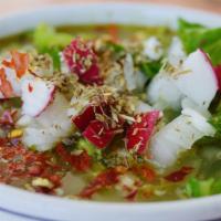 Pozole · Mexico city style Hominy, garnished with lettuce, chopped radish and onions, tortilla chips,...