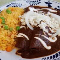Enchiladas De Mole · Three mole sauce enchiladas. Our signature handy crafted mole poblano sauce has been rated a...