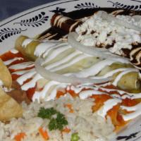 Enchiladas Tricolor · Three enchiladas, one topped with red sauce, second with green sauce and third with our sign...