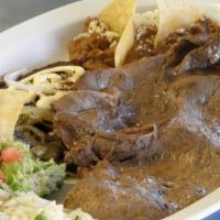 Tampiqueña · Combination of flank beef steak (Angus quality) with rice, refried beans, mole sauce enchila...