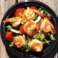 Garlic Shrimp Arugula · Butter and garlic-marinated shrimp with arugula and drizzled with chef's sauce.