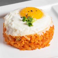 Kimchi Fried Rice · Stir-fried napa kimchi fried rice with bacon, cheese, sunny-side-up egg, and sesame oil.