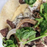 El Chico Sandis · Carne asada, grilled onions, cilantro, and delicious housemade queso on your choice of torti...