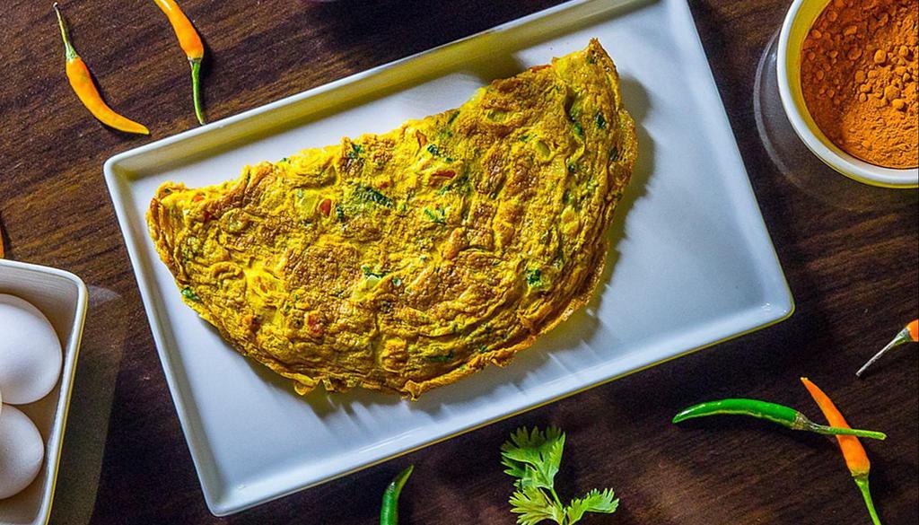 Desi Omelette · Omelette made with onions, tomatoes, and chillies.