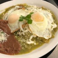 Ranchero Eggs · Two fried eggs on tortilla bathed in green or ranchera sauce accompanied by refried black be...