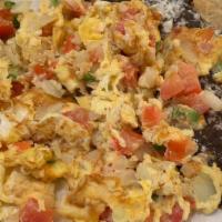 Fresh Eggs · Spicy. Two scrambled eggs with tomato, onion and chopped serrano peppers accompanied by refr...