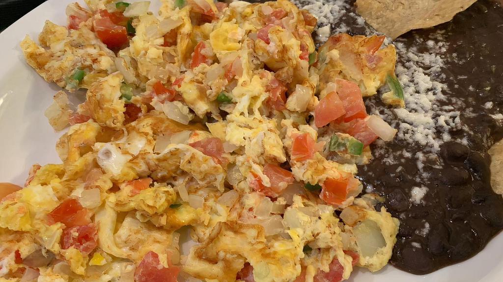 Fresh Eggs · Spicy. Two scrambled eggs with tomato, onion and chopped serrano peppers accompanied by refried black beans.