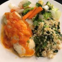 Stuffed Fish · Fish fillet stuffed with spinach, pecans, and cream cheese with tomato sauce. Seved with ric...