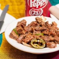 Tibbs · Beef cubes and sauteed in kibe (Ethiopian clarified butter), and seasoned with onions, tomat...
