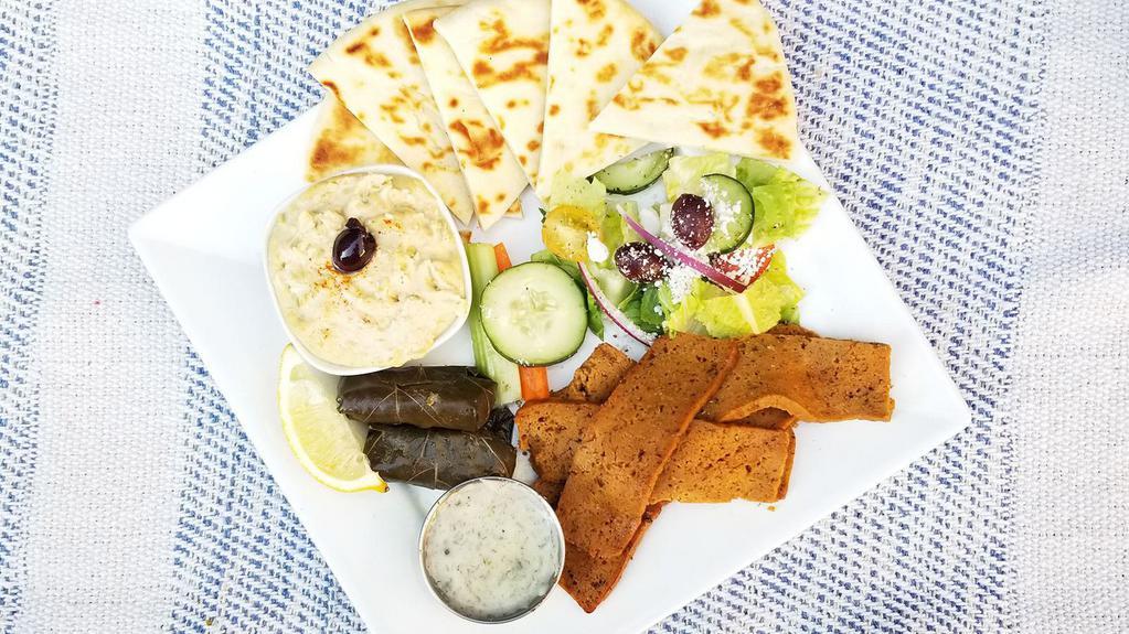 Seitan Gyro Platter · Vegan. House made Seitan seasoned with our secret herbs and spices, sliced thin, served with dolmades, hummus, side salad, warm pita, fresh cut vegetables, and tzatziki or choice of sauce.