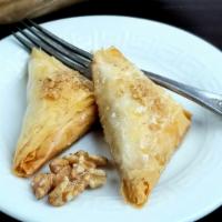 Baklava (2 Pieces) · Vegan. Spiced walnuts in flaky phyllo triangles and drenched in sweet agave syrup.