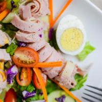 Cobb Salad · Romaine hearts, marinated grilled chicken, avocados, cucumbers, tomatoes, corn, eggs, and ba...