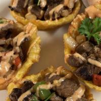 Tostones Rellenos · Four fried plantain cups stuffed with steak.