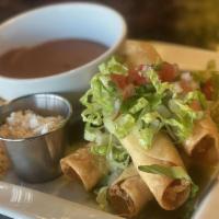 Chicken Flautas · 4 Crispy corn tortillas stuffed with shredded chicken topped with sour cream and queso fresc...