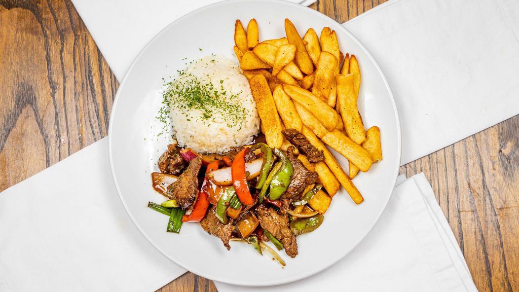 Lomo Salteado · Sautéed beef tenderloin with red onions, bell peppers and tomatoes served with white rice and fries.
