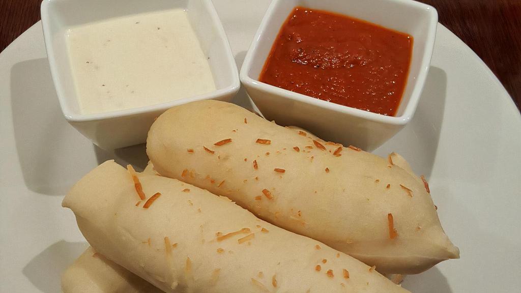 Handmade Breadsticks · 5 homemade breadsticks served with a side of marinara and alfredo sauce