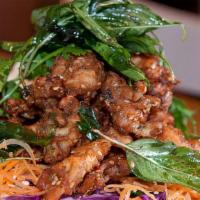 Thai Herbal Chicken · Crispy chicken infused with Thai herbs and seasonings. Topped with crispy basil leaves