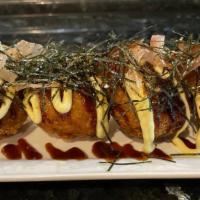 Takoyaki (4) · Octopus wheat balls served with tonkatsu sauce, mayo and topped with fish flakes and seaweed.