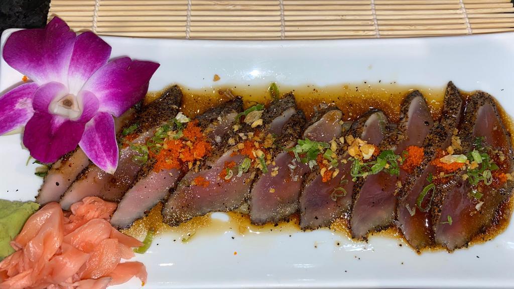 Pepper Tuna Tataki (8) · Seared pepper tuna topped with scallions and fried garlic in house sauce.