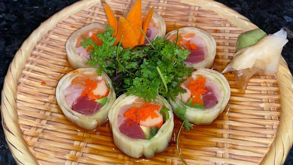Naruto (6) · Salmon, tuna, yellowtail, crab stick and avocado wrapped in cucumber topped with masago in ponzu sauce. (No rice, no seaweed).
