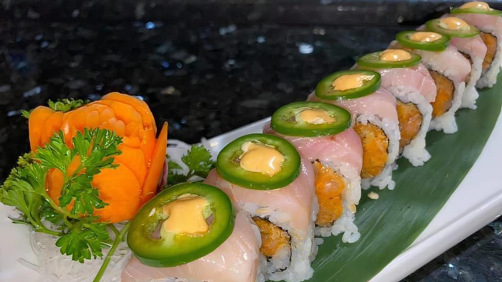 Ichiban Roll · Spicy Salmon, asparagus inside, yellowtail and sliced jalapeno on top with rice seasoning, spicy mayo and ponzu sauce.