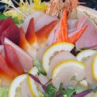 Fancy Sashimi Deluxe · Two pieces of each blue fin tuna, yellow tail salmon. sweet shrimp and white tuna, two surf ...