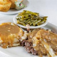 Hamburger Steak · Freshly grilled hamburger steak smothered in brown gravy and grilled onions.