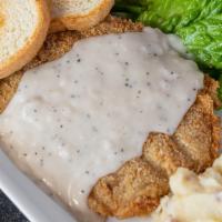 Chicken Fried Steak · Topped with white cream gravy and served with mashed potatoes and sauteed green beans.