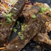 Caribbean Jerk Ribs · Slow smoked and finished with our housemade spicy mango jerk sauce.