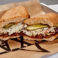 Pulled Pork Bbq Sandwich · Pulled pork in a sweet spicy sauce with pickles and cole slaw