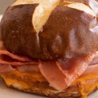 Ham & Cheese Pretzel Bun Sandwich · Smoked ham and cheddar cheese on a pretzel roll toasted together when ordered.