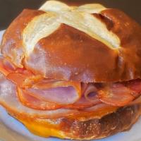 Club Sandwich  · Turkey, ham, bacon & cheddar on a pretzel roll. Served hot.