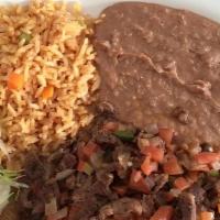 Bistec Ala Mexicana · Beef strips grilled with fresh-cut tomatoes, onions, peppers, rice, beans, and salad.