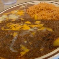 Enchiladas Rancheras · Two chicken enchiladas covered with ranchero sauce, served with rice and beans.