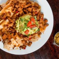Chik'N Nachos · Local, non-gmo tortilla chips covered with chik'n, bell peppers, onions, queso & guacamole