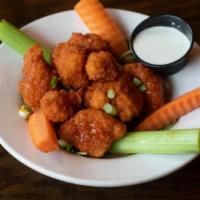 Cauliflower Bites · Lightly battered and fried cauliflower florets tossed in choice of buffalo, bourbon BBQ, or ...