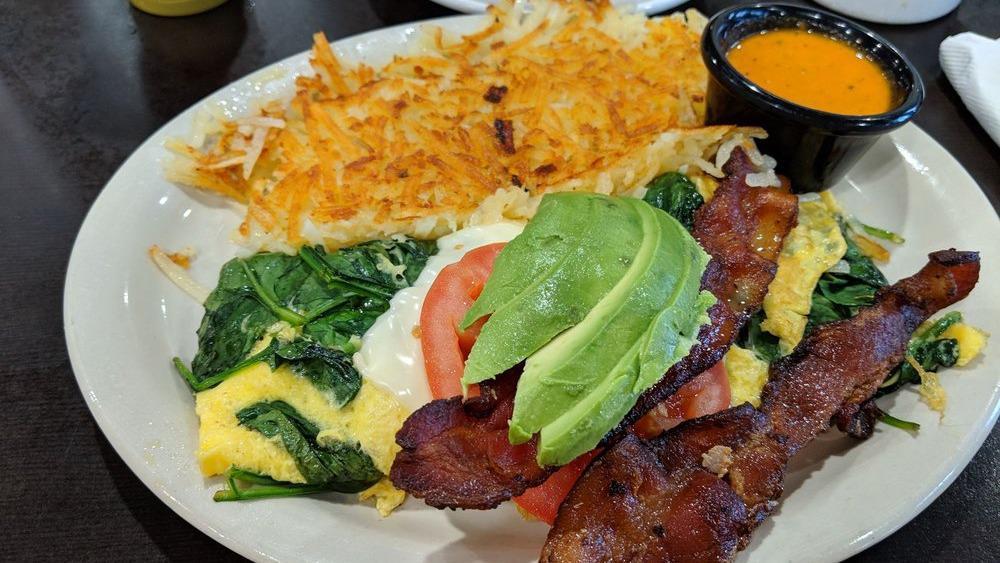 Blt Omelette · 2 eggs omelette style with spinach and Swiss cheese. Topped with 2 sliced tomatoes, 2 strips pt bacon and sliced avocado, served with country potatoes or hashbrowns toast or a biscuit.