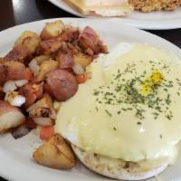 Egg Benedict Breakfast · 2 poached eggs set over english muffin with ham and topped with hollandaise sauce served wit...