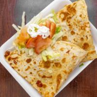Quesadillas · A corn or flour tortilla filled with melted white cheese and your choice of meat.