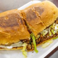 Torta · Mexican bun with beans your choice of meat lettuce and tomatoes with melted cheese and avoca...