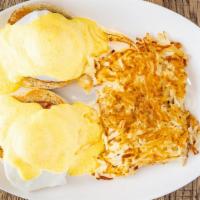 Eggs Benedict · Two poached eggs with canadian bacon on toasted english muffin halves topped with hollandais...