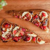 Almond Butter Toast · Organic, gluten free, vegan toast! Almond butter, banana, hemp seeds, strawberries, cacao sy...