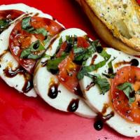 Caprice Salad · Slices of Roma tomato and mozzarella flavored with fresh basil leaves, olive oil, salt & pep...