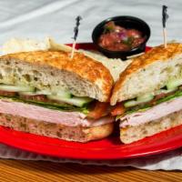 Dragon Sandwich · Turkey, provolone, tomatoes, mix of spinach, cucumbers and our blend of basil-infused extra ...