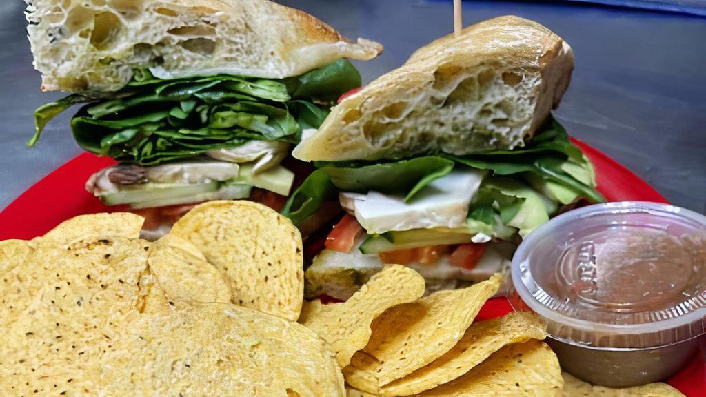 Green Dragon · Provolone, tomatoes, sliced mushrooms, avocados, cucumbers, mix of spinach and romaine with our blend of basil-infused extra virgin olive oil on toasted focaccia or as a wrap.